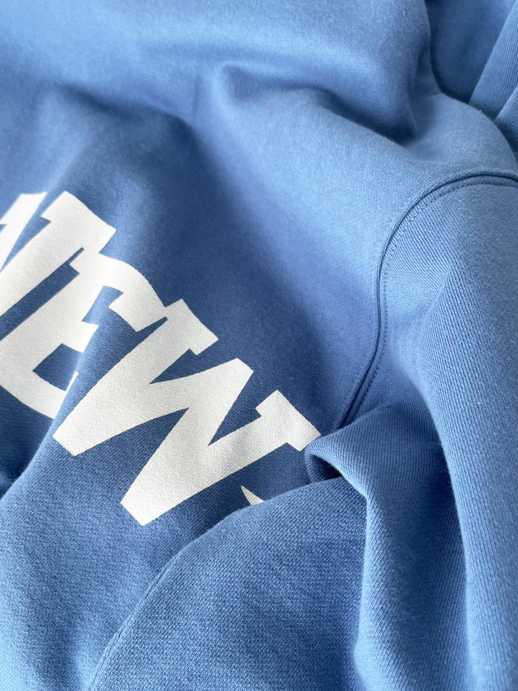 Unisex blue hoodie for travel, comfort, and resort wear